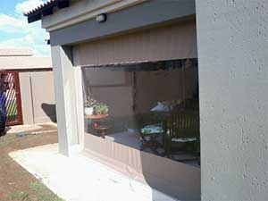 Gear operated roller blind with clear PVC window outside